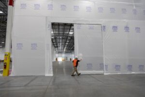 Opening Pocket Door in a large Framless Wall being used for dust protection interior protection 